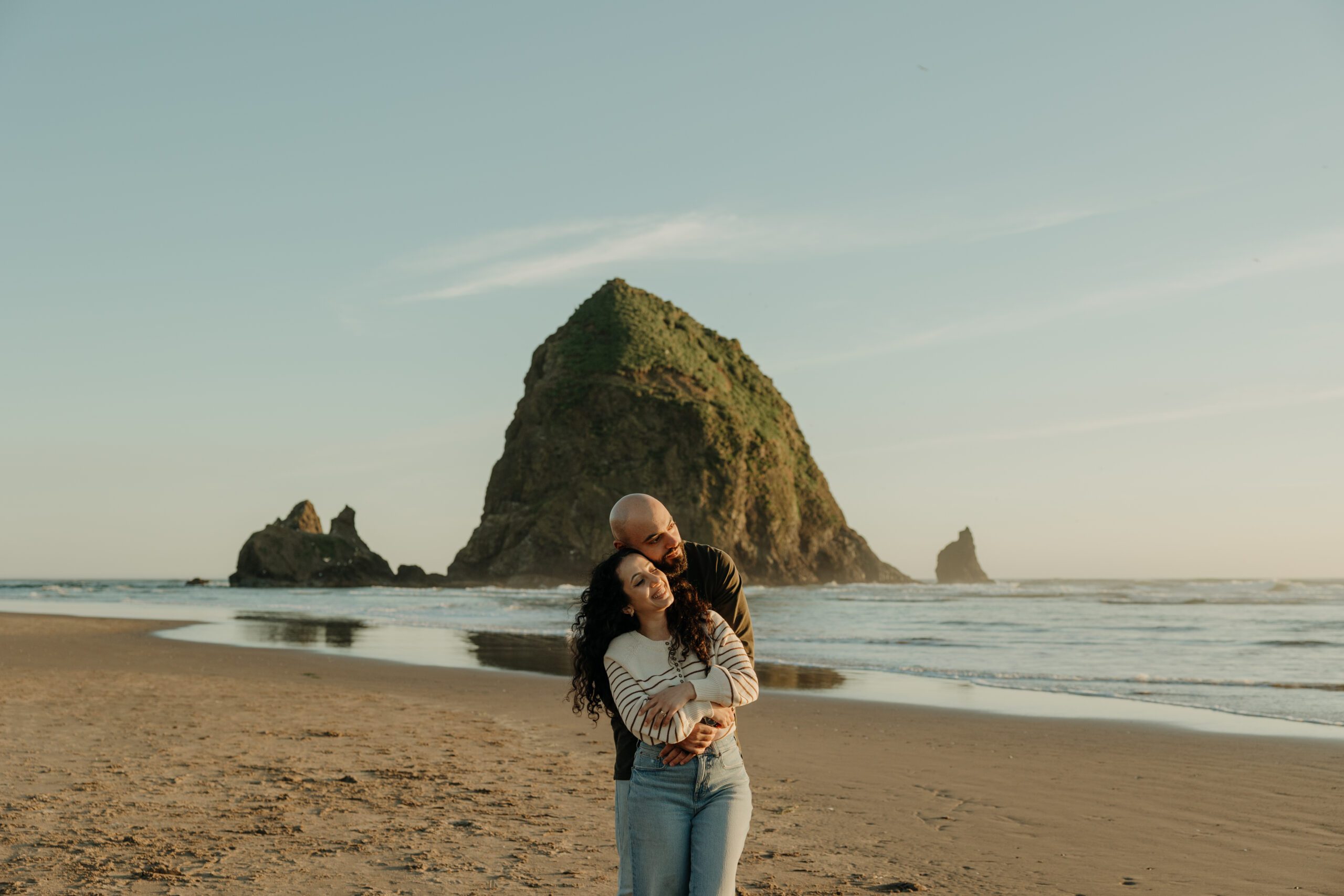 Couple during sunset at Haystack Rock, Cannon Beach Oregon