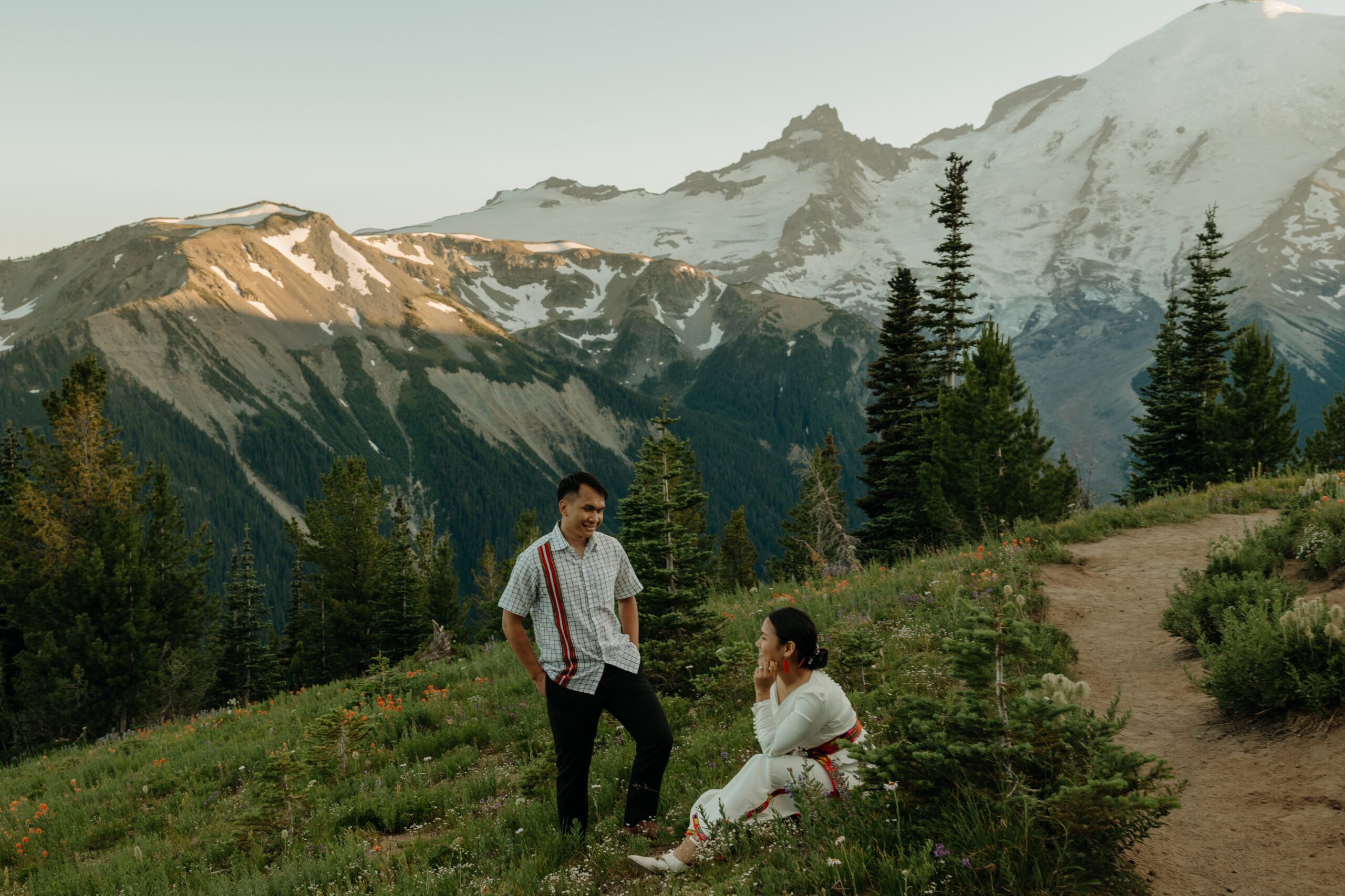 Couple posing in wildflower field at Mount Rainier National Park for engagement photos
